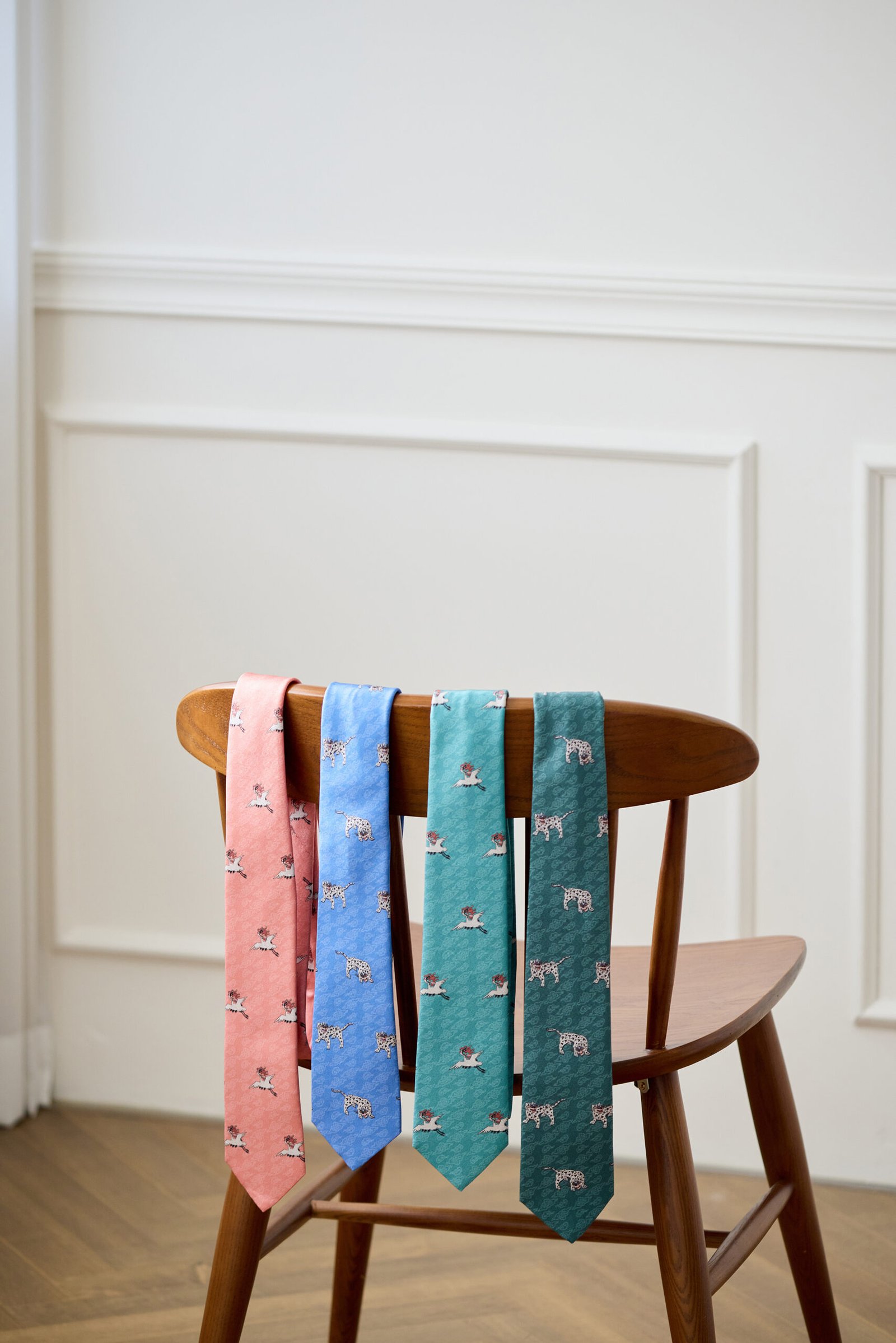 Four silk neckties in pink, blue, teal, and dark green with crane and tiger motifs drawn from Joseon hyungbae rank badges
