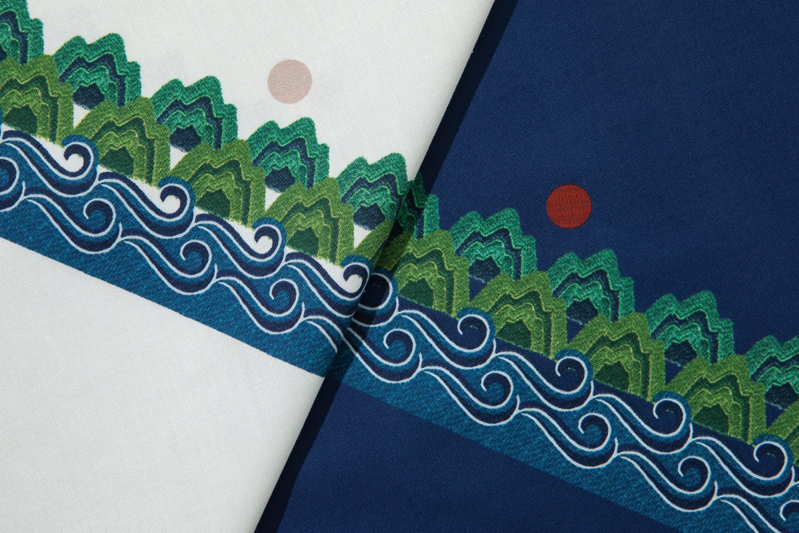 Close-up of the Ilwol Sansu-bo pattern printed on cotton, showing mountains, waves, and the sun reinterpreted from Ilwol Obongdo